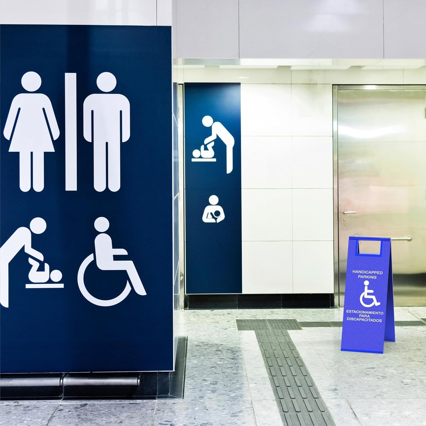 Blue disability parking sign with wheelchair symbol placed in modern building hallway for ADA compliance