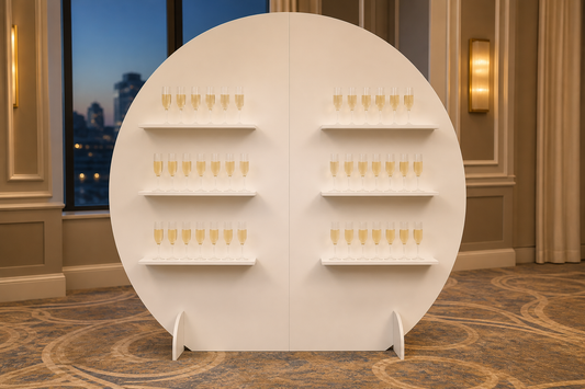 White six-shelf champagne wall with controlled warm lighting in an evening hotel ballroom