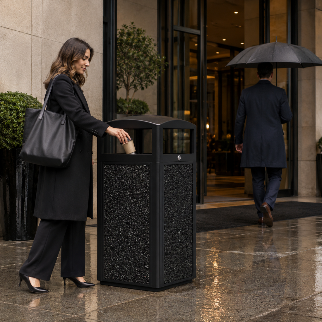 Outdoor metal trash can near a hotel entrance, helping guests dispose of waste quickly without slowing down