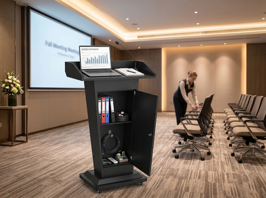 Black wooden podium storage in a hotel meeting room with laptop, microphone, open cabinet, and organized event supplies