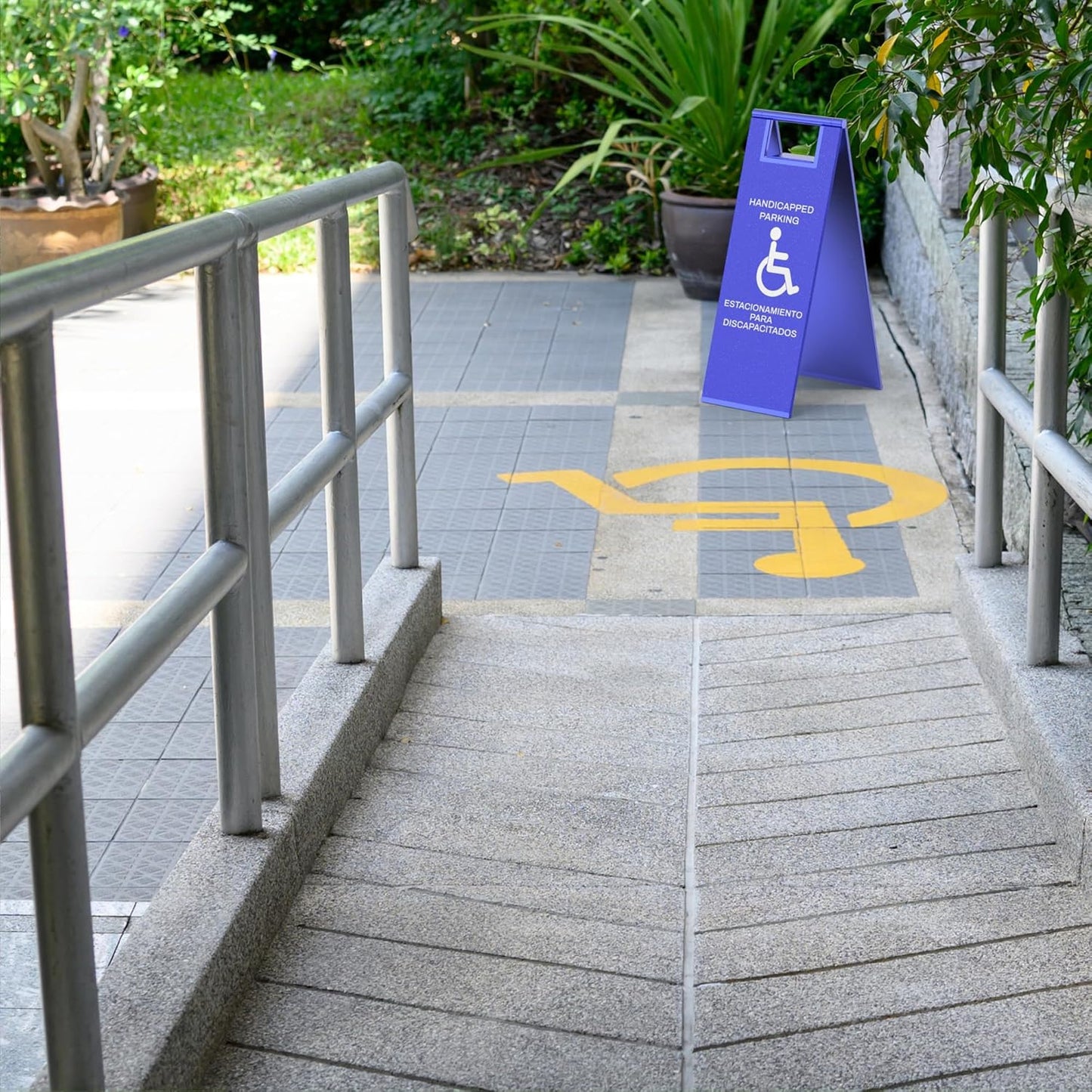 Blue ADA parking sign with wheelchair symbol marking accessible entrance ramp with painted ground markings