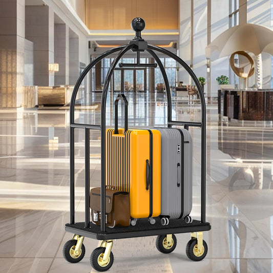 Commercial grade black hotel luggage cart positioned in elegant marble hotel lobby. Professional dome-style bellman cart with protective overhead canopy, loaded with guest luggage including yellow and gray suitcases. Durable hospitality equipment designed for high-traffic hotel environments with polished floors and upscale interior design.