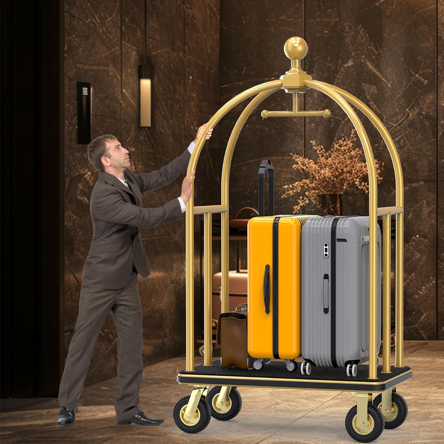 Professional hotel staff member operating gold-finished hotel luggage cart in luxury hotel lobby. Bellman cart service demonstration showing proper guest luggage handling with multiple suitcases including yellow and gray bags. Hospitality professional using commercial-grade luggage trolley for efficient baggage transportation in upscale hotel environment.