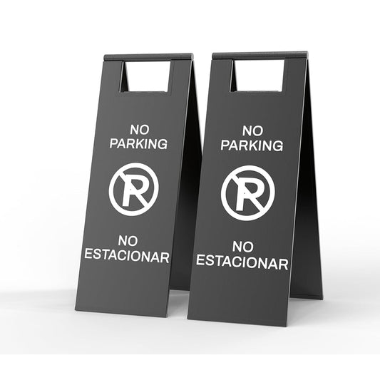 Two gray no parking signs with prohibited symbol and bilingual English Spanish text for parking enforcement