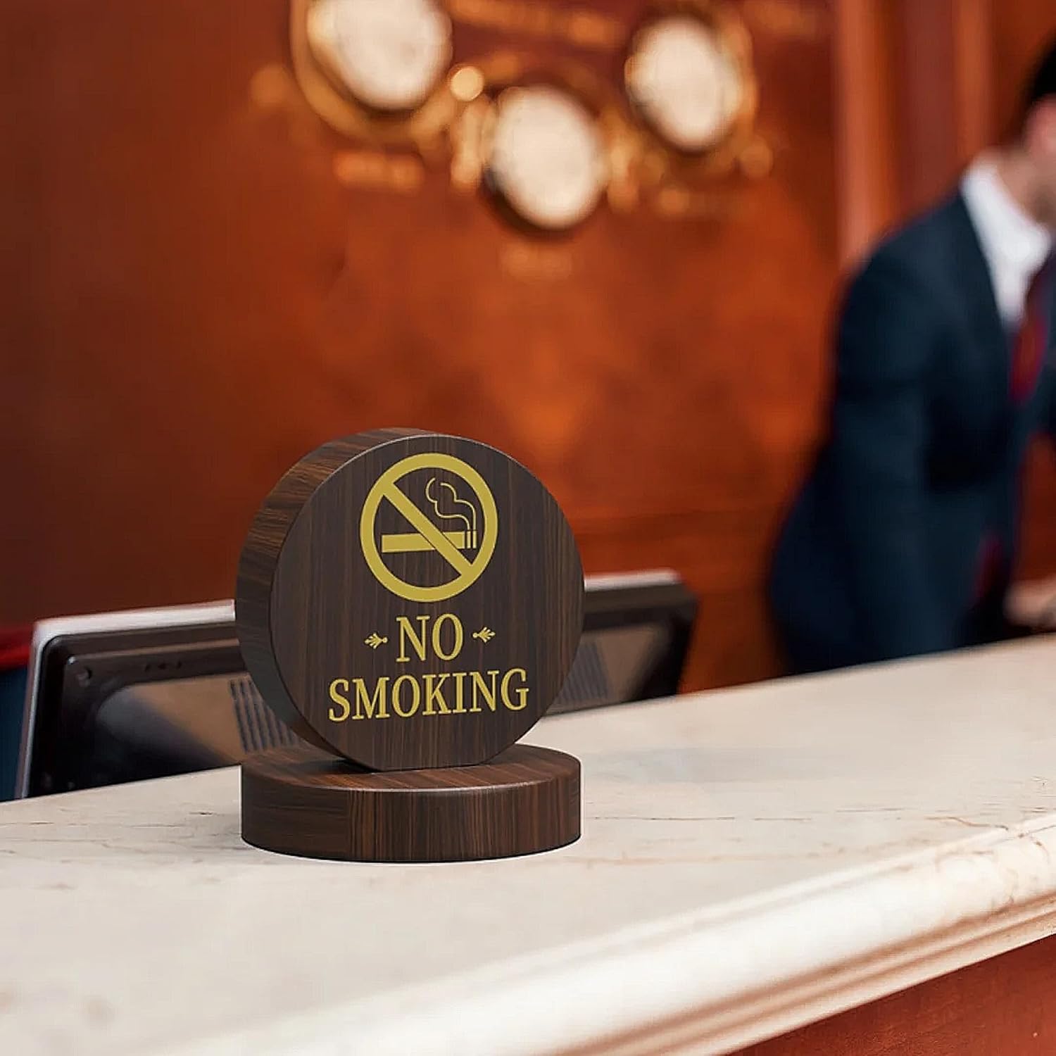 No smoking wooden table sign displayed in upscale business dining environment with suited professional in background