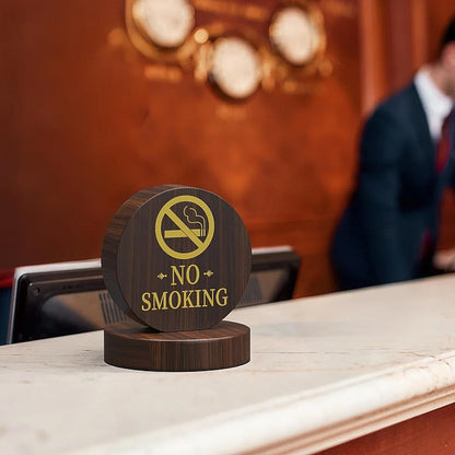 No smoking wooden table sign displayed in upscale business dining environment with suited professional in background