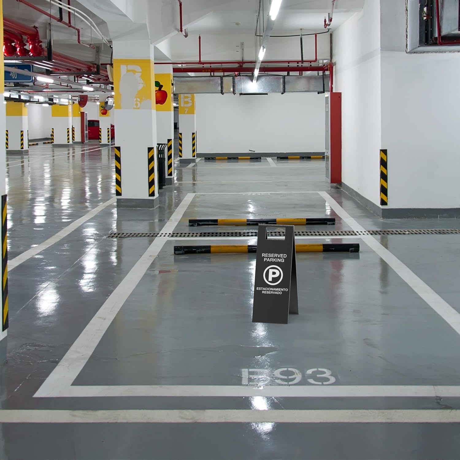 Reserved parking a-frame sign placed in underground parking garage showing practical commercial application of portable parking signs