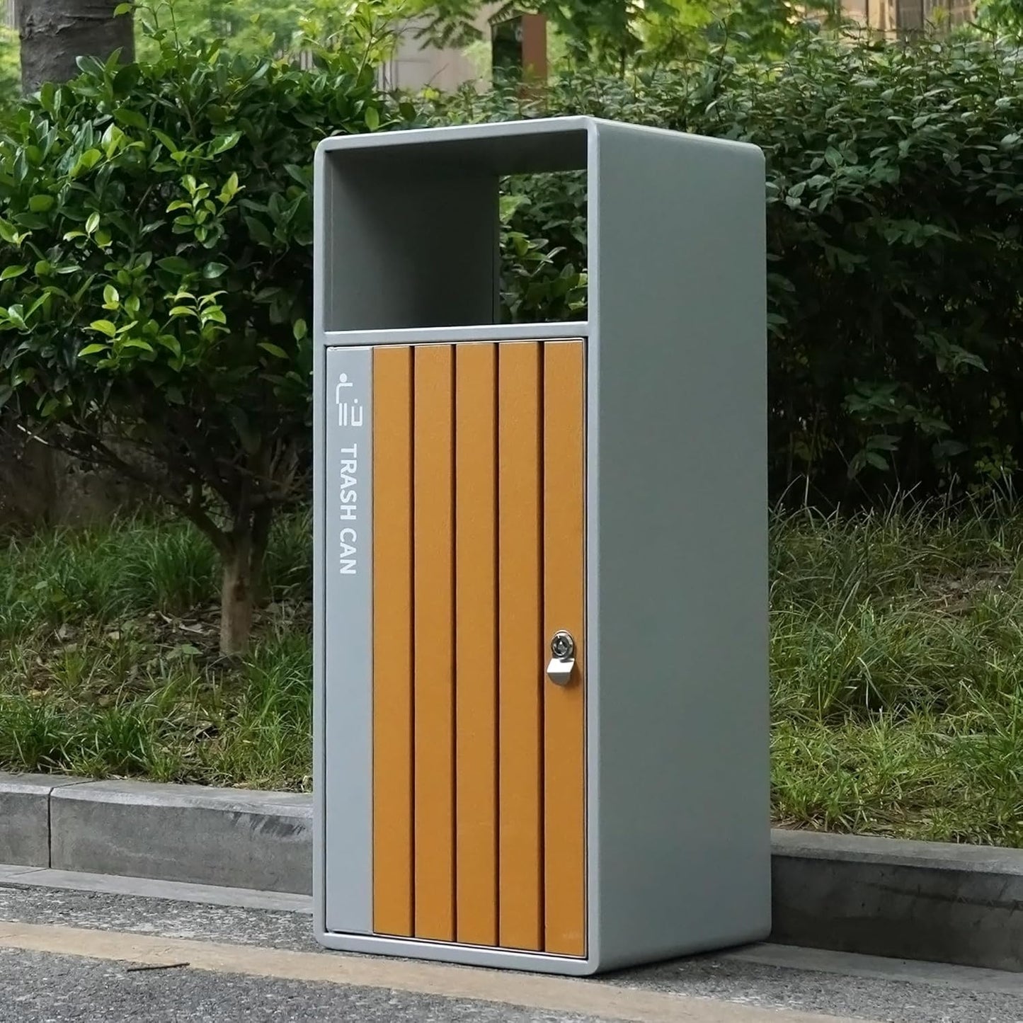 Residential outdoor trash receptacle with natural wood slat door and secure locking mechanism, placed in garden environment