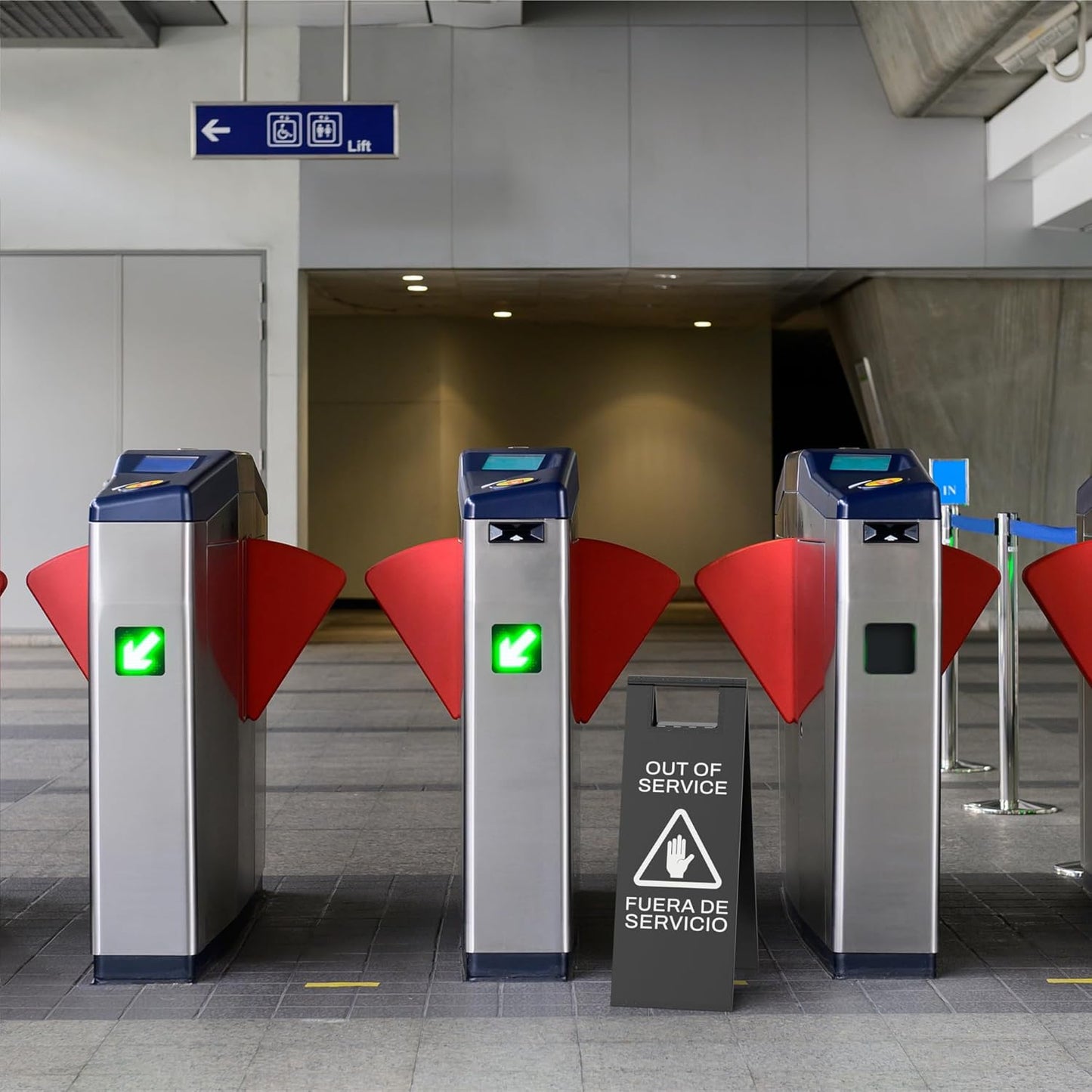 Black temporary out of service sign with hand symbol blocking access to subway turnstile gates during repair