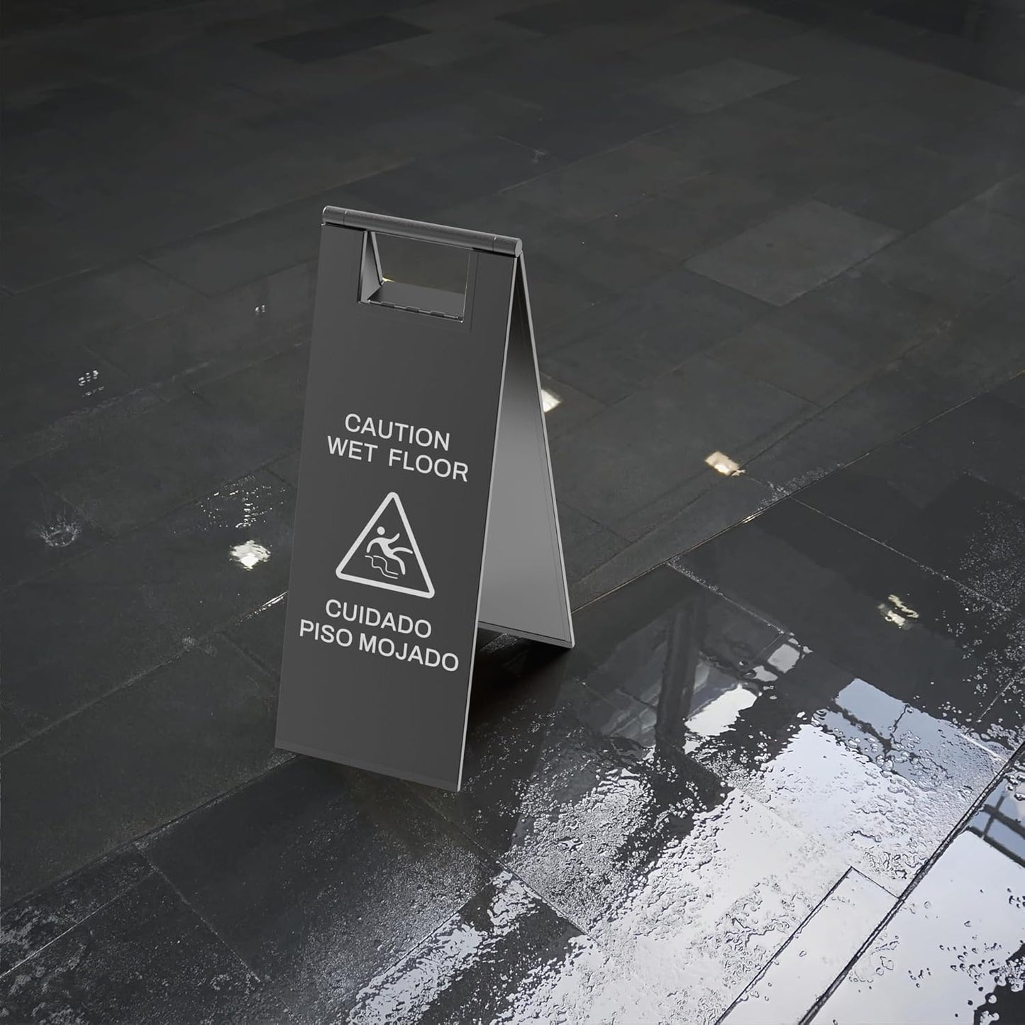 Caution wet floor a-frame sign placed on actual wet slippery floor surface demonstrating real-world safety warning application