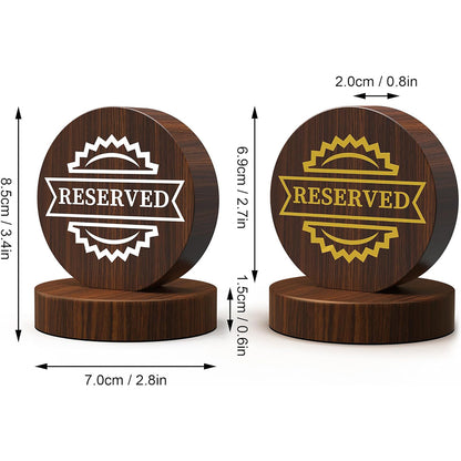 Product dimension comparison showing two wooden reserved table signs with measurements in centimeters and inches