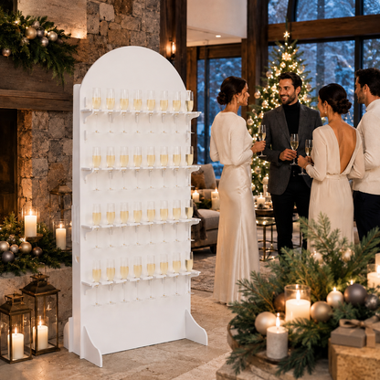 White 32-flute champagne wall stand at an evening celebration with candles and warm string lights